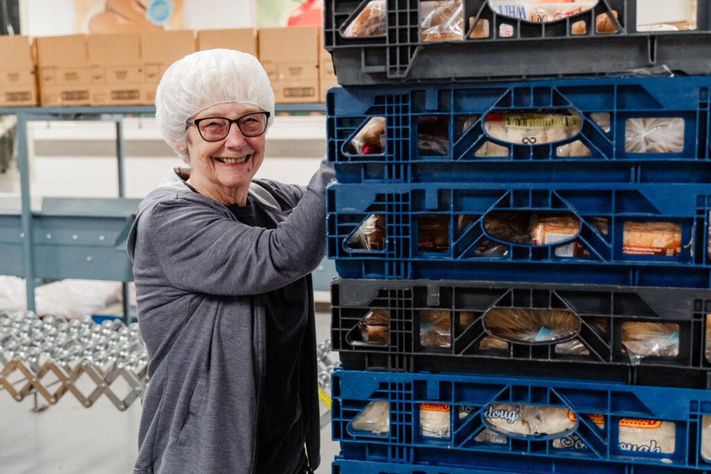 A volunteer sorts bread at Second Harvest