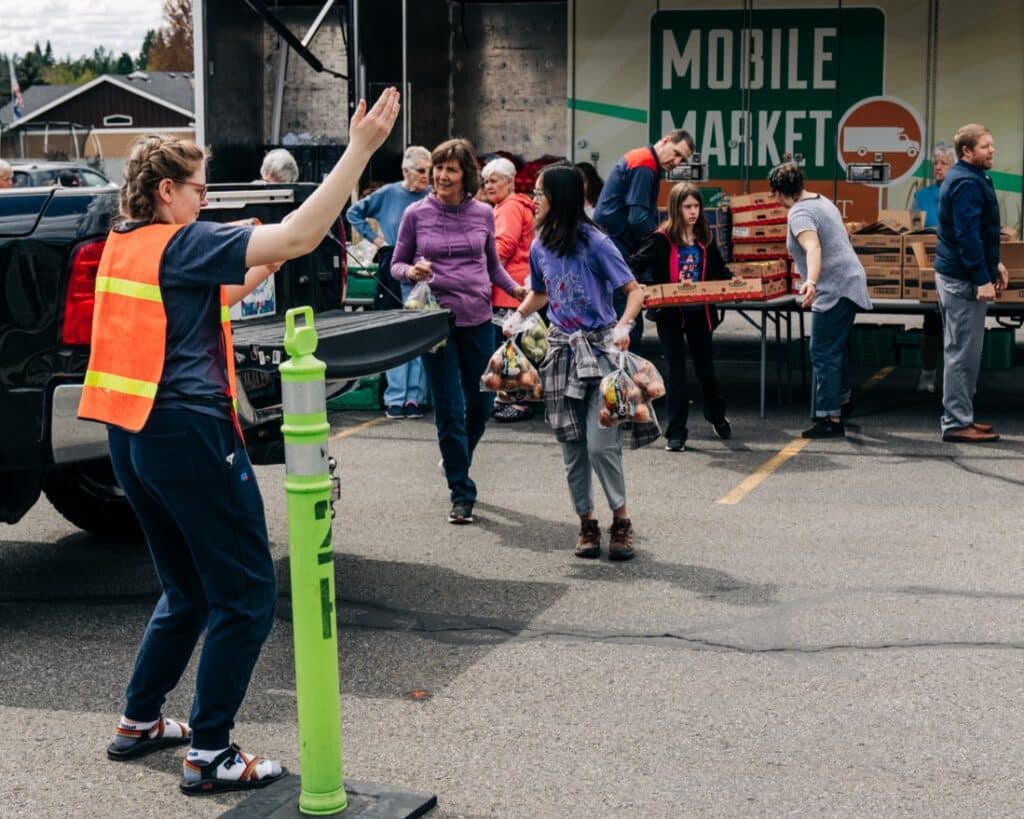 Volunteers distribute food at a Mobile Market event