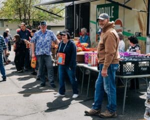 Volunteers distribute food at a Mobile Market event
