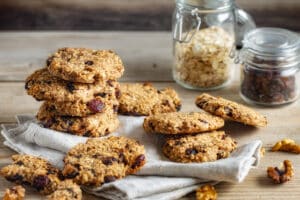 Oat cookies with cranberry and raisins on wooden table
