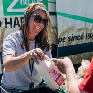 Handing out milk at a mobile market