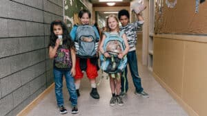 Kids eating snacks in a school hallway