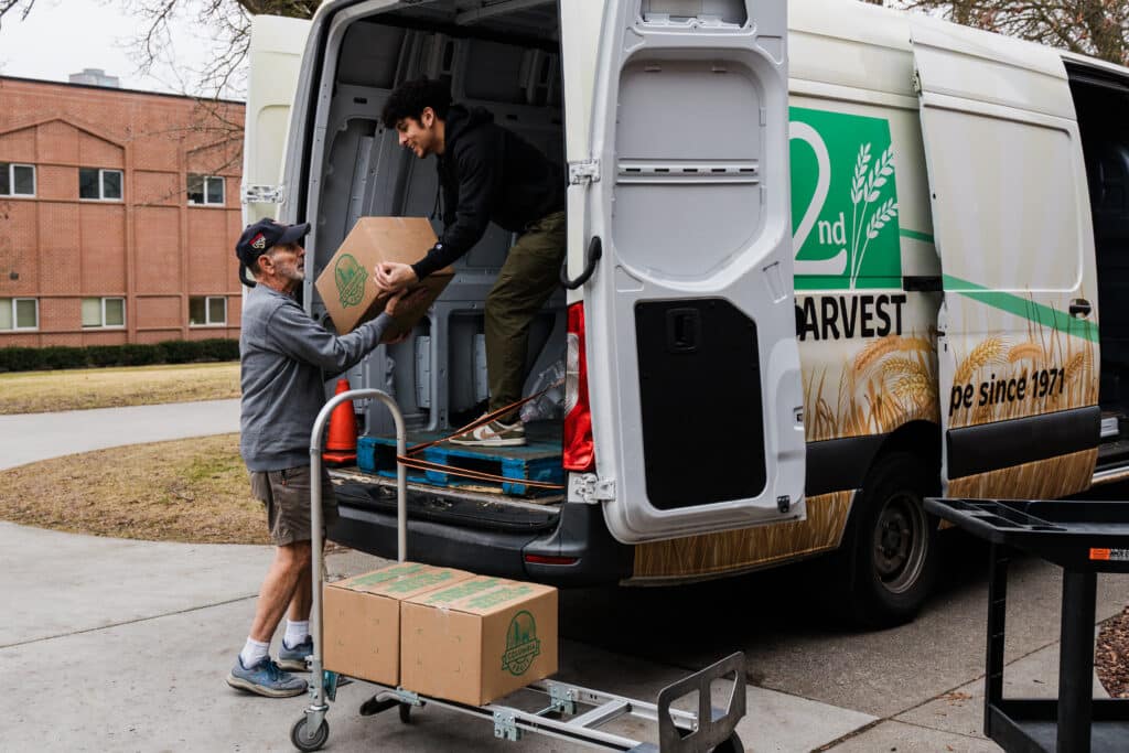 Volunteers unload food at a Mobile Market at SFCC