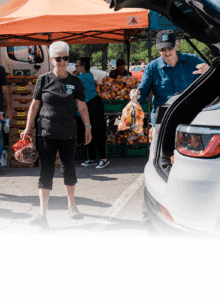 Volunteers distribute food at a Mobile Market