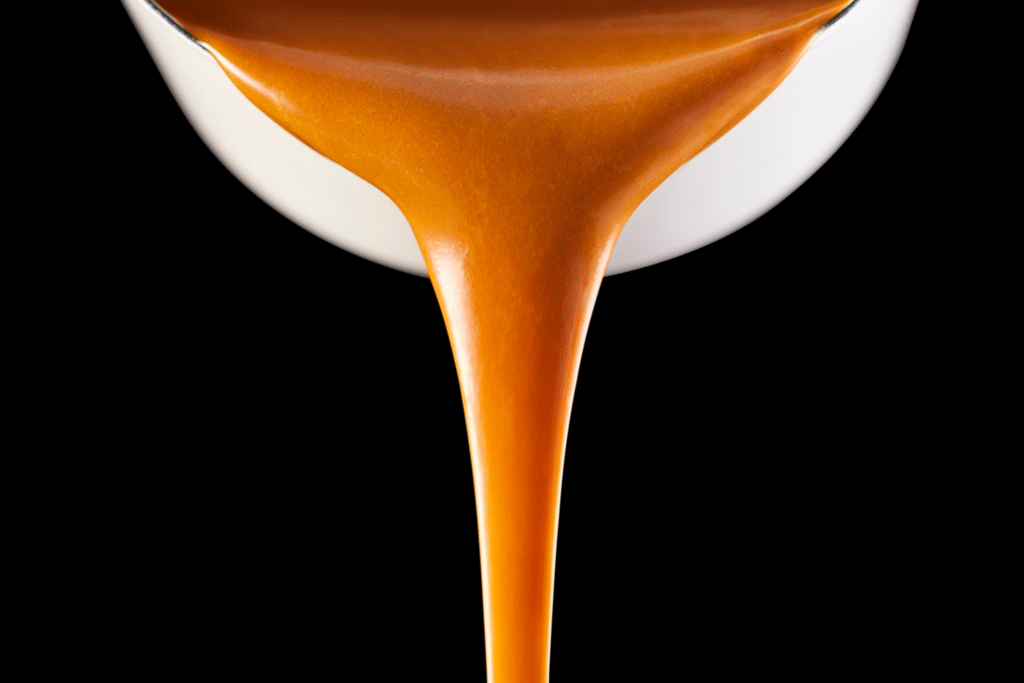 Peanut sauce pouring out of a jar