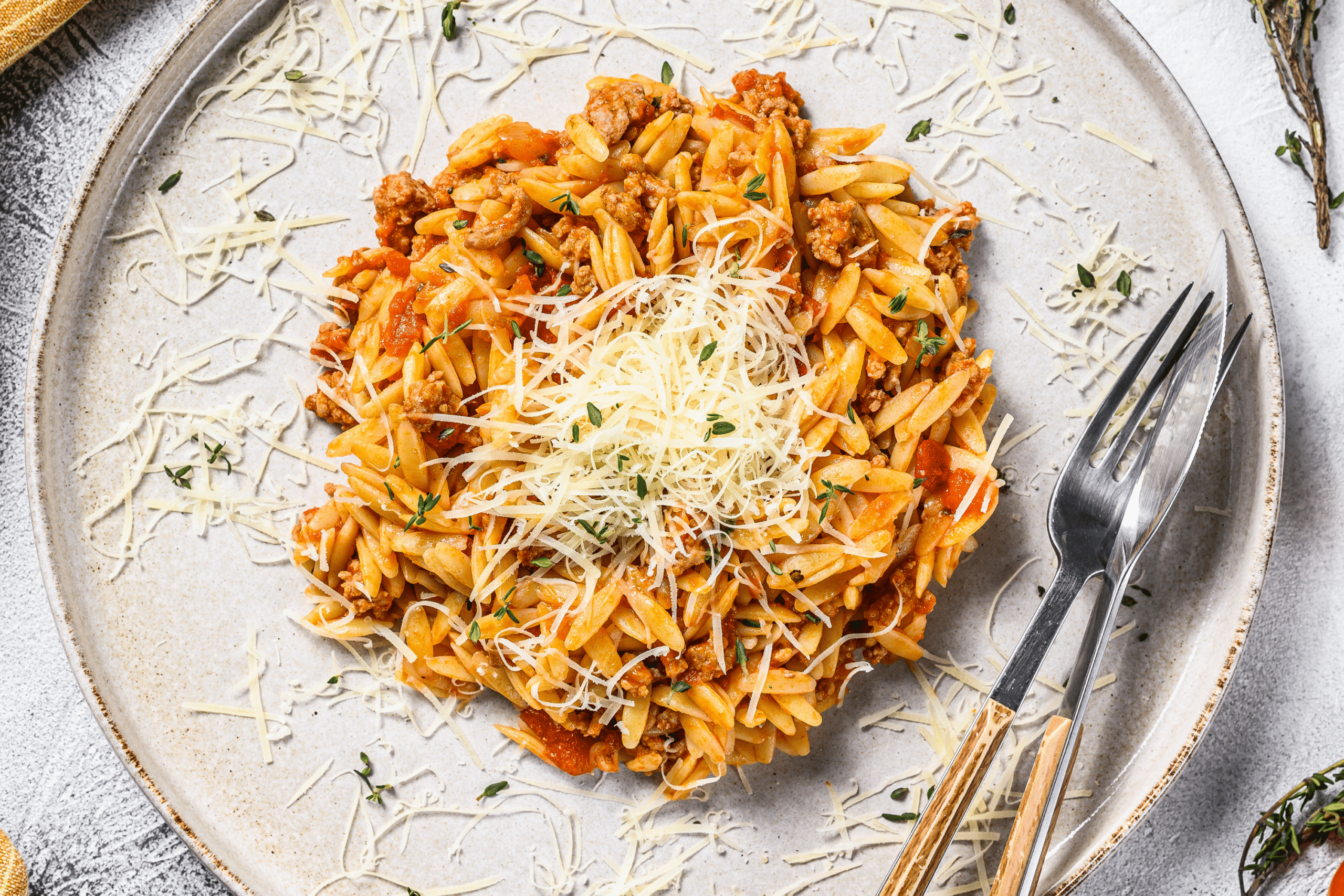 Orzo on a plate with silverware