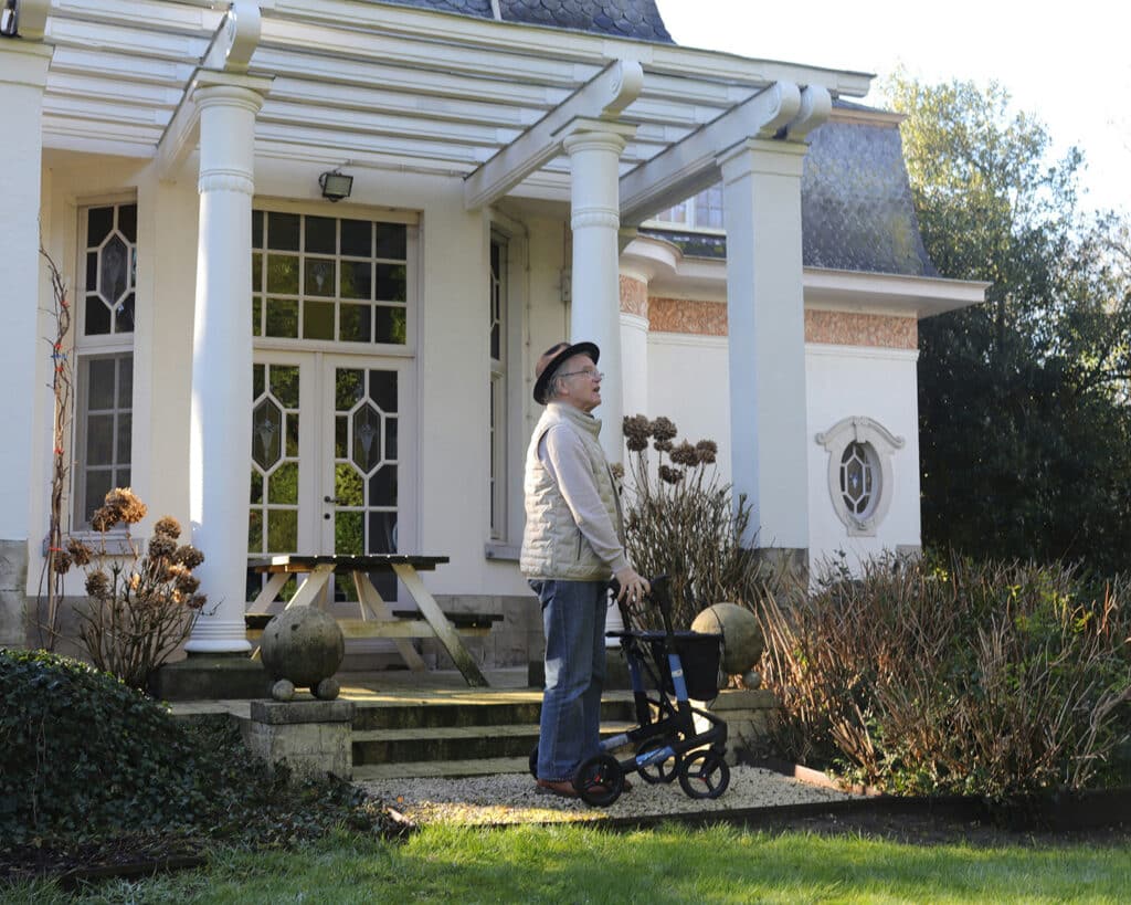 Person walking in front of a house. Photo by Mobio Marketing on Unsplash