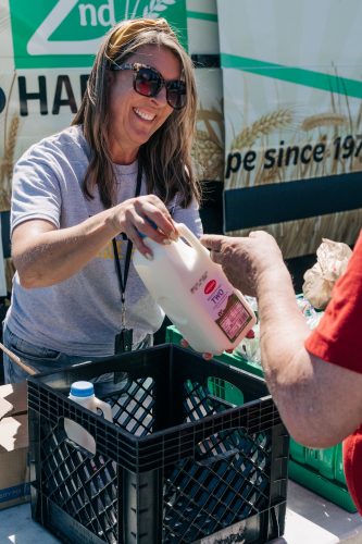 A volunteer helps distribute food at a Mobile Market event